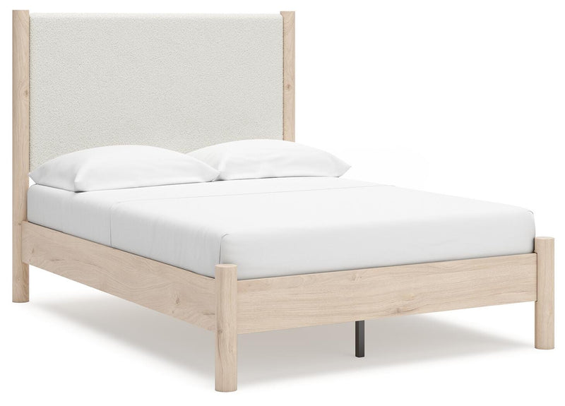 Ashley Furniture Cadmori upholstered bed with a modern design, featuring a padded headboard and neutral fabric upholstery.