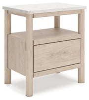 Ashley Furniture Cadmori nightstand with a dark wood finish and modern design, shown from an angled side view.