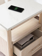 Ashley Furniture Cadmori nightstand with a dark wood finish and modern design, featuring a single drawer and sleek metal handle.