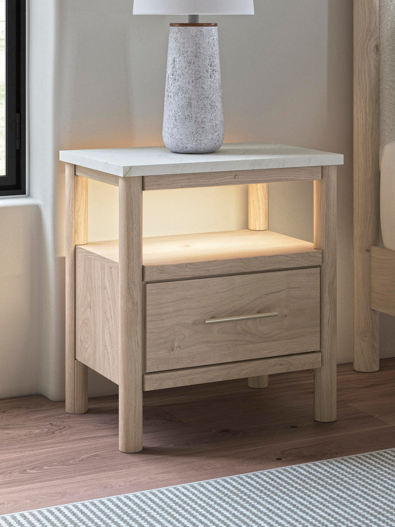 Ashley Furniture Cadmori nightstand with a sleek wood finish and modern design, featuring a single drawer and open shelf.
