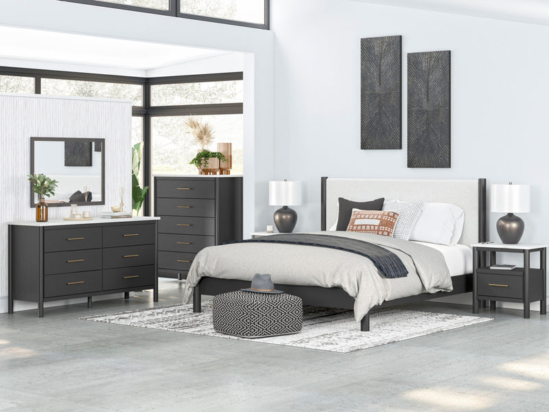 Ashley Furniture Cadmori upholstered bed with plush fabric and a modern design, shown in a stylish bedroom setting.