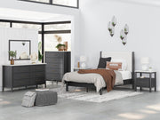 Ashley Furniture Cadmori upholstered bed with a padded headboard and neutral fabric, shown in a stylish bedroom setting.