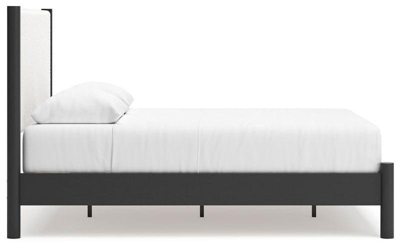 Ashley Furniture Cadmori bedroom set with a modern bed, matching nightstands, and dresser in a stylish bedroom setting.