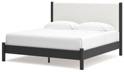 Ashley Furniture Cadmori upholstered bed with a padded headboard and elegant design, shown from an angled side view.