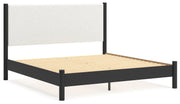 Ashley Furniture Cadmori upholstered bed with a padded headboard and sleek design, shown from an angled side view.