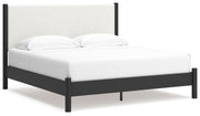 Ashley Furniture Cadmori upholstered bed with plush fabric headboard, shown from a stylish angled side view.