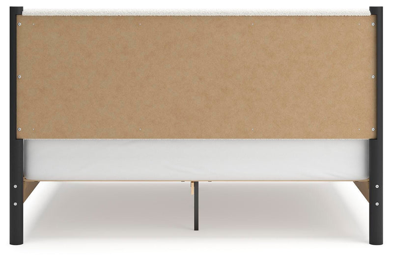 Ashley Furniture Cadmori upholstered bed with headboard and neutral fabric, shown in a well-lit bedroom setting.