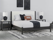 Ashley Furniture Cadmori upholstered bed with a plush fabric headboard and elegant design, shown in a modern bedroom setting.