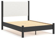 Ashley Furniture Cadmori upholstered bed with a padded headboard and sleek design, shown from an angled side view.