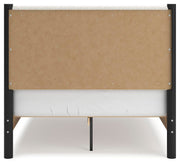 Ashley Furniture Cadmori upholstered bed with a padded headboard and sleek design, shown in a stylish bedroom setting.