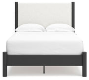 Ashley Furniture Cadmori upholstered bed with a padded headboard and neutral fabric, shown from a front head-on view.