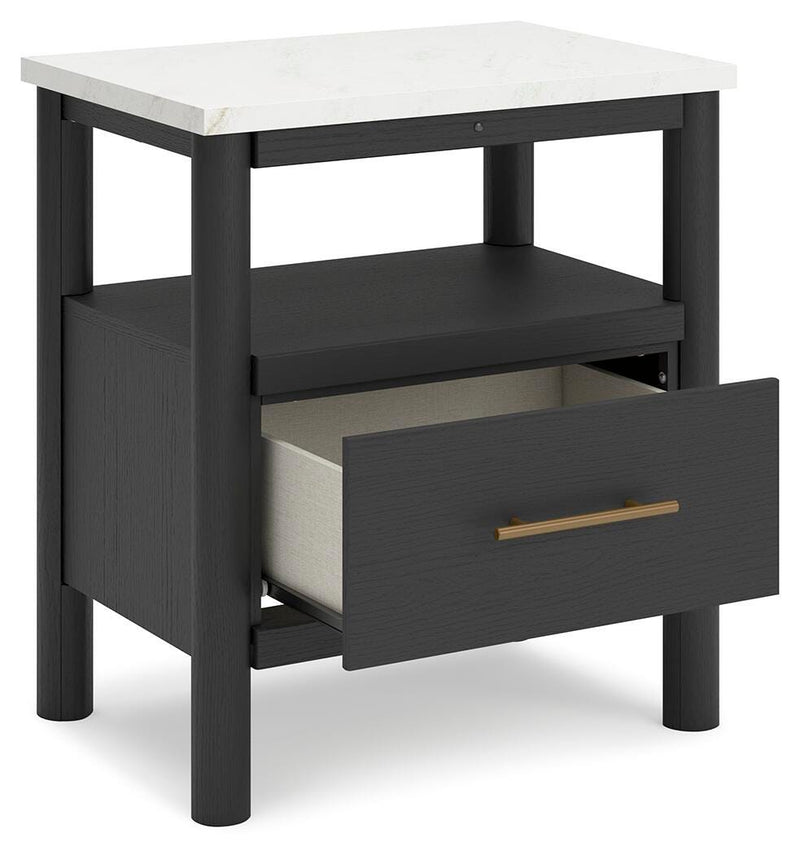 Ashley Furniture Cadmori bedroom set with a bed, dresser, and nightstands shown from an angled view in a modern bedroom setting.