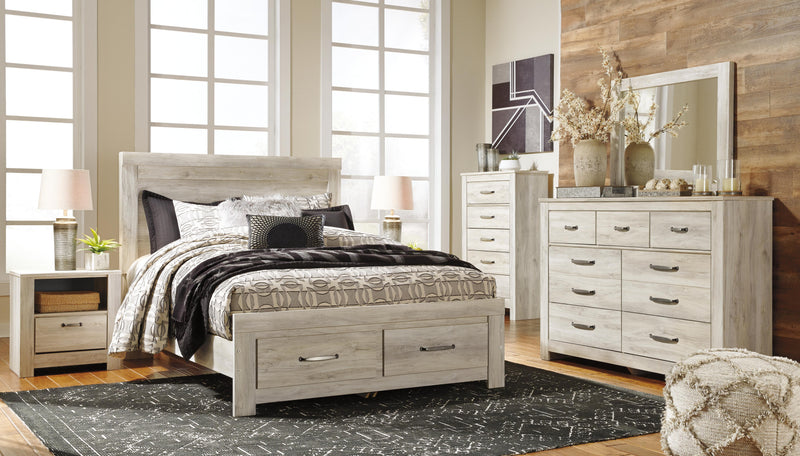 Ashley Furniture Bellaby bed with two storage drawers, featuring a sturdy frame and sleek design in a modern bedroom setting.