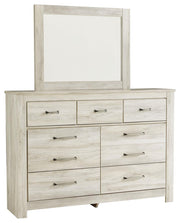Ashley Furniture Bellaby bedroom set featuring a bed frame, dresser, and nightstands in a modern bedroom scene.