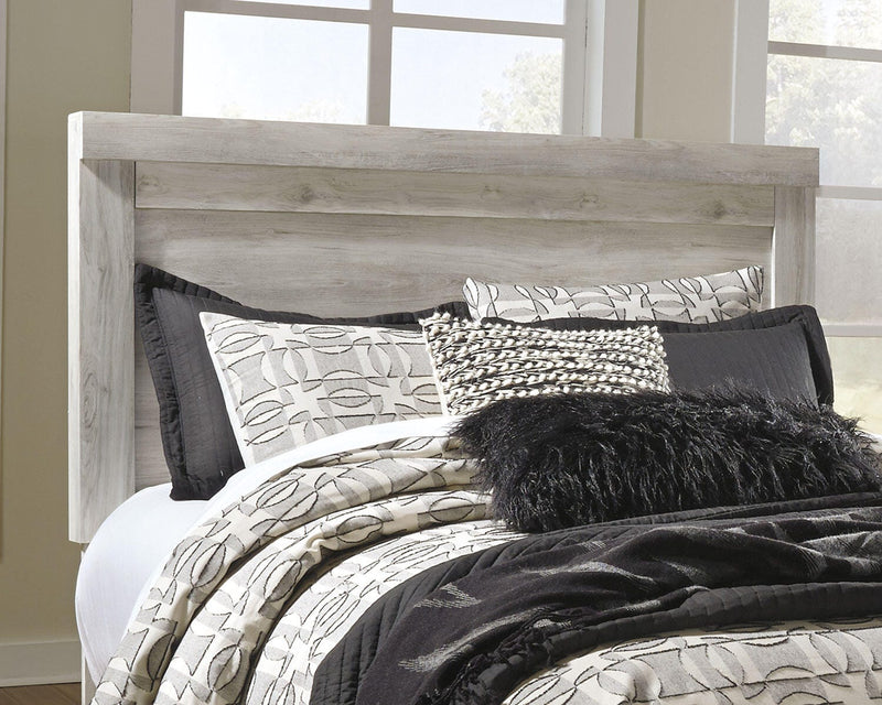 Ashley Furniture Bellaby bed with two storage drawers, featuring a modern design and sturdy wooden frame in natural finish.