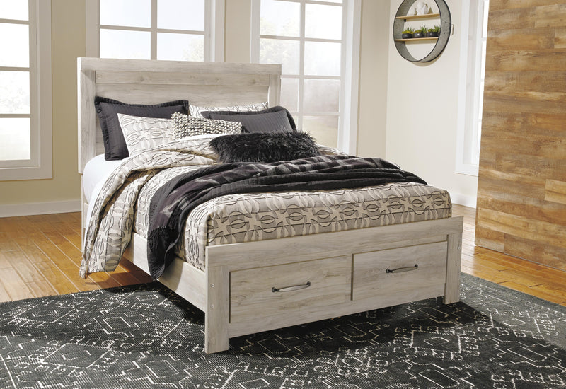 Ashley Furniture Bellaby bed with two storage drawers, featuring a modern wooden frame and built-in under-bed storage.