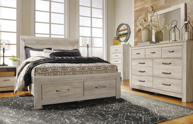 Ashley Furniture Bellaby bed with two storage drawers, featuring a modern wooden frame and built-in under-bed storage.