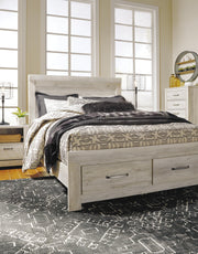 Ashley Furniture Bellaby bed with built-in storage drawers, showcasing a modern bed frame with two functional storage drawers underneath.