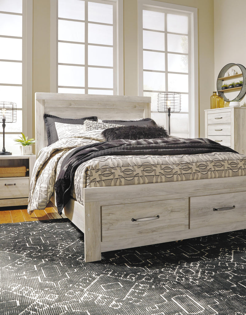 Ashley Furniture Bellaby bed with built-in storage drawers, showcasing a modern bed frame with two functional storage drawers underneath.