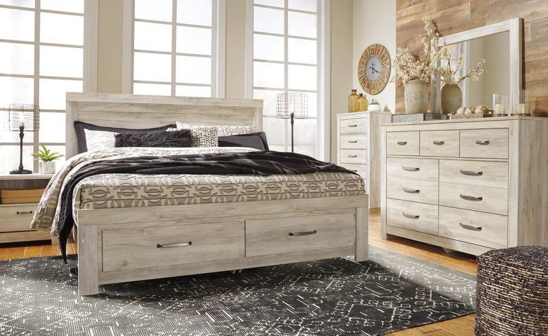 Ashley Furniture Bellaby Bed with two storage drawers, featuring a sturdy frame and modern design in a bedroom setting.