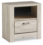 Ashley Furniture Bellaby nightstand with a dark wood finish and sleek drawer handle, shown with a modern bedroom setting