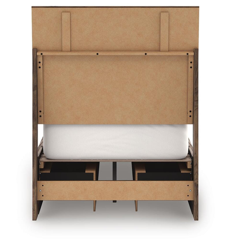 Ashley Furniture Chirason Bed with a dark wood finish and elegant headboard, shown from the back in a well-lit bedroom setting.