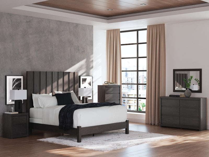 Ashley Furniture Fraluna chest of drawers with multiple drawers, finished in a warm wood tone, shown in a modern bedroom setting.
