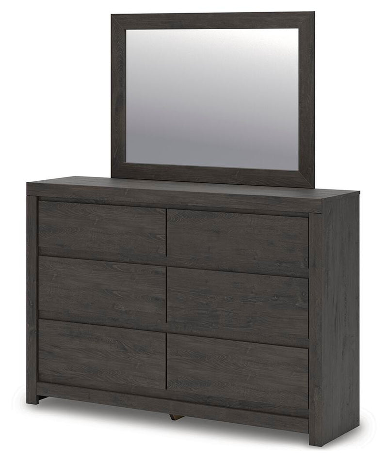 Ashley Furniture Fraluna dresser with attached mirror, showcasing a sleek wooden finish and modern design from a side angle.
