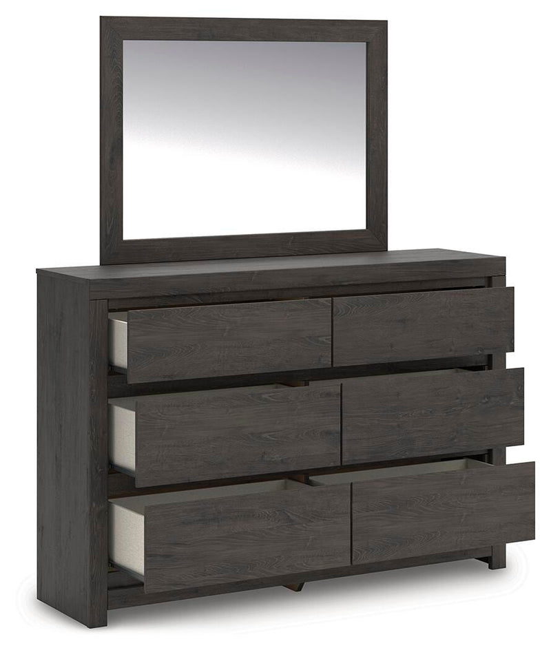 Ashley Furniture Fraluna bedroom set with a bed, nightstands, and dresser in a modern bedroom layout.