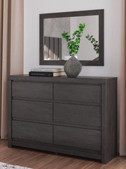 Ashley Furniture Fraluna bedroom set with a bed, nightstands, and dresser in a modern design, shown in a cozy bedroom setting.