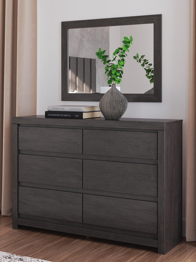 Ashley Furniture Fraluna bedroom set featuring a wooden bed frame, matching nightstands, and a dresser with modern design.