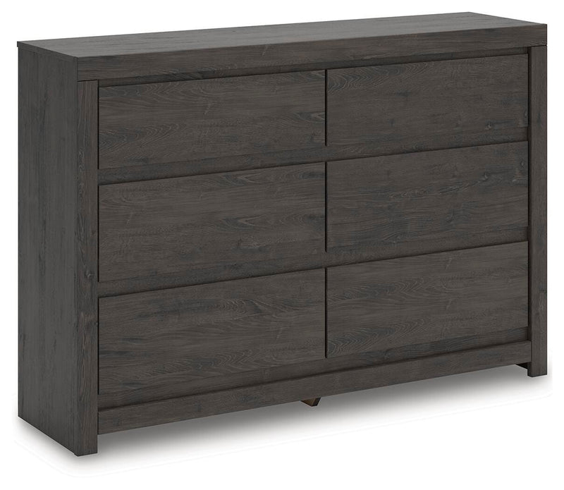 Ashley Furniture Fraluna dresser with multiple drawers, shown from an angled view, showcasing its modern design and wood finish.