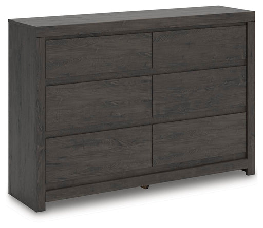 Ashley Furniture Fraluna dresser with multiple drawers, shown from an angled view, showcasing its modern design and wood finish.