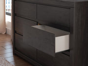Close-up of the Ashley Furniture Fraluna Dresser with detailed wood finish and modern design features.