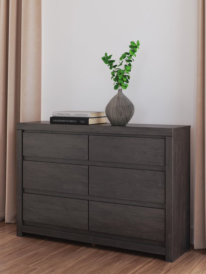 Ashley Furniture Fraluna Dresser with sleek wood finish and multiple drawers for stylish storage in a modern bedroom setting.