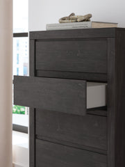 Ashley Furniture Fraluna chest of drawers with detailed wood finish and multiple storage drawers for bedroom organization.