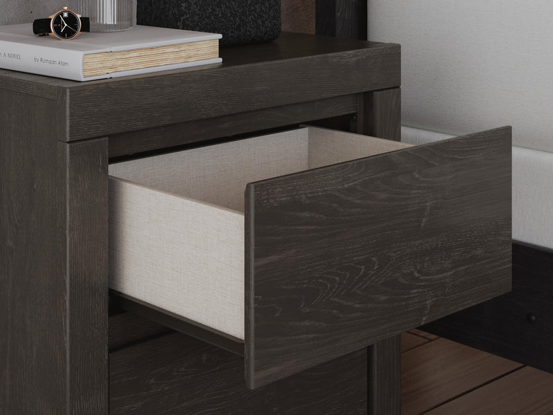 Ashley Furniture Fraluna bedroom set featuring a sleek bed frame with matching nightstands and dresser in a modern design.