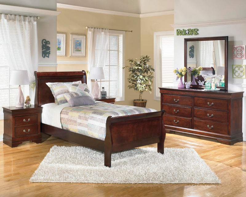 Ashley Furniture Alisdair bedroom set featuring a modern bed frame, matching nightstands, and coordinating dresser in a stylish bedroom setting.