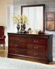 Ashley Furniture Alisdair Dresser and Mirror set with a wooden dresser featuring multiple drawers and a matching mirror on top.