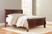 Ashley Furniture Alisdair Bed with a sturdy wooden frame and classic design, shown in a cozy bedroom setting.