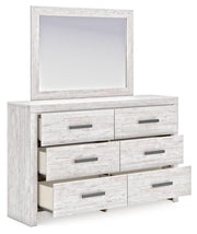 Ashley Furniture Cayboni Dresser with Mirror, showing the dresser's wood finish and the attached mirror from a side angle.