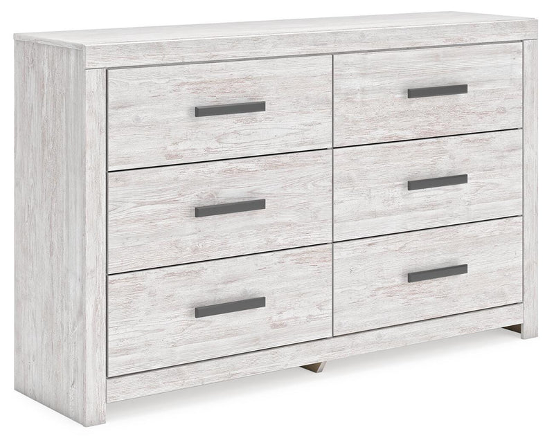 Ashley Furniture Cayboni dresser with multiple drawers, shown from an angled side view in a modern bedroom setting.