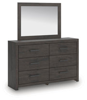 Ashley Furniture Prendonea dresser with matching mirror, showcasing a modern wood finish and sleek design from an angled side view.