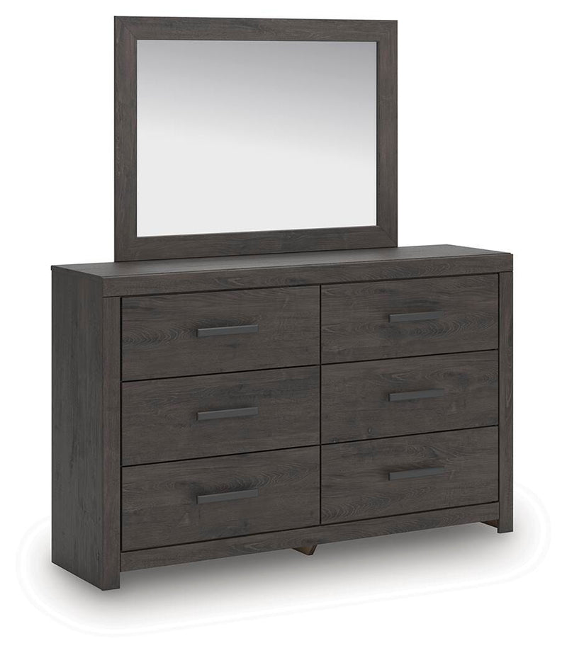 Ashley Furniture Prendonea dresser with matching mirror, showcasing a modern wood finish and sleek design from an angled side view.