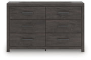 Ashley Furniture Prendonea dresser with multiple drawers and sleek wood finish, shown from a front head-on view.