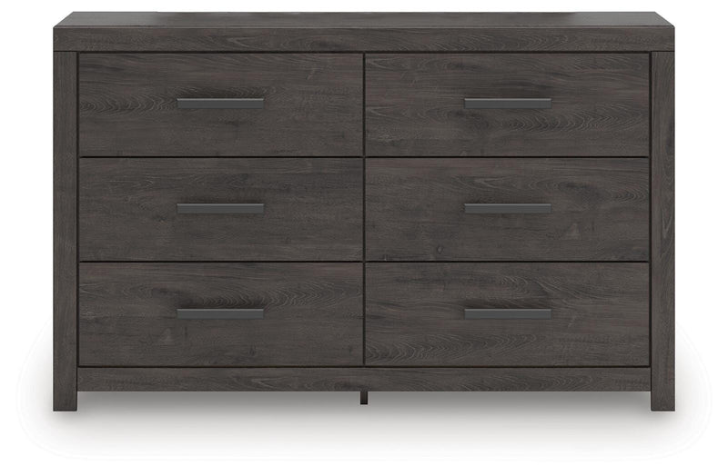 Ashley Furniture Prendonea dresser with multiple drawers and sleek wood finish, shown from a front head-on view.