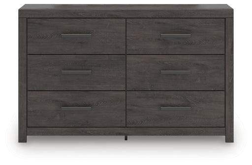 Ashley Furniture Prendonea dresser with multiple drawers and sleek wood finish, shown from a front head-on view.