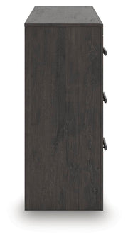 Ashley Furniture Prendonea dresser with sleek wood finish and multiple drawers, shown from a side view.