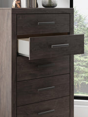Ashley Furniture Prendonea chest of drawers with detailed wood finish and multiple drawers in a classic bedroom setting.