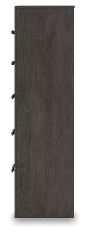 Ashley Furniture Prendonea chest of drawers with a sleek wooden finish and multiple storage drawers on a white background.